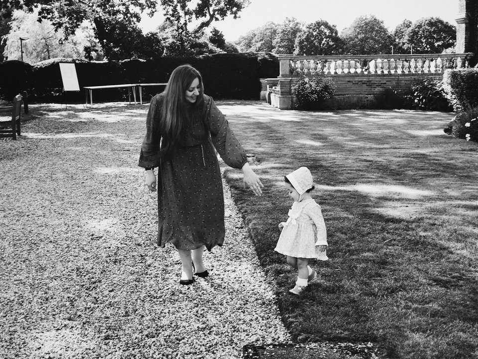 Mia Rassel with her daughter — a quiet moment of presence in a garden